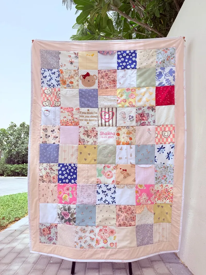Peach-bordered memory quilt with a name and birth date block